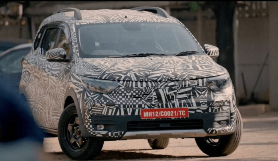 Camouflaged car parked on street.